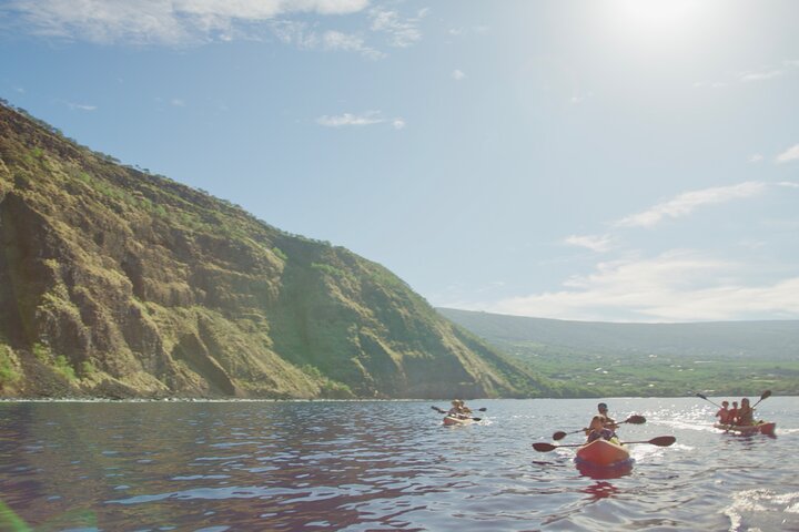Kayakers coastal cliff sea