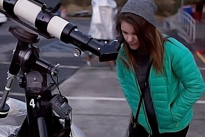 Visitor at a telescope on a mountain