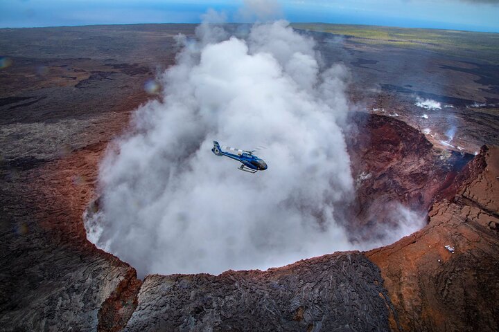 Helicopter above a steaming crater