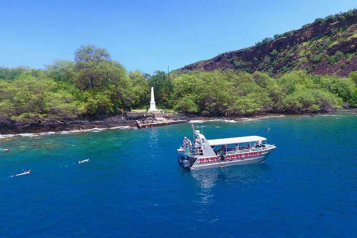 Aerial view of a bay with a boat near the monument